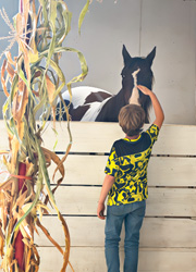 Child petting horse at Hathaway Farm and Corn Maze